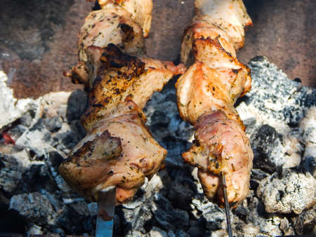shish kebab, pork meat on skewers, grilled on the grillの写真素材
