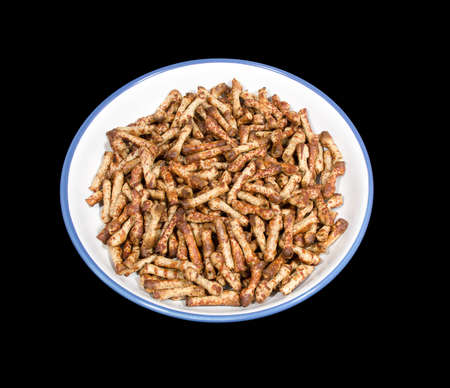 Bowl of Twiglets isolated on a Black Backgroundの写真素材