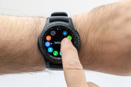 CHESTER, UK - January 28, 2017: Samsung Gear S3 smartwatch shown on a male wrist and operating the...