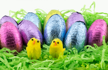 Easter Eggs on green shredded paper with yellow chickens
