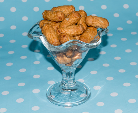 Cocktail sausages in a glass bowl on a blue backgroundの写真素材