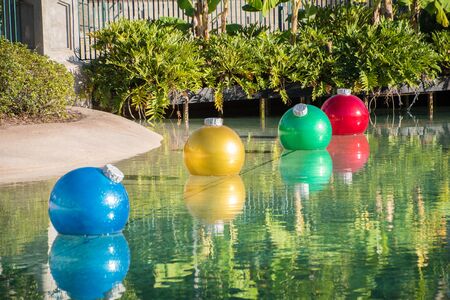 Different coloured floating Christmas baublesの写真素材
