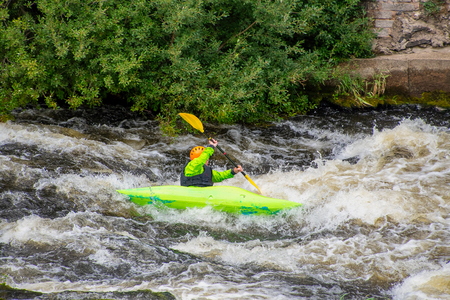 White water kayaker canoeing through rapids on the River Deeの写真素材