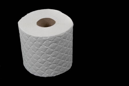 Single white toilet roll isolated on a black backgroundの写真素材