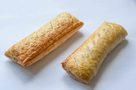 Cooked sausage rolls on a white backgroundの写真素材