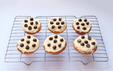 Homemade cupcakes with a buttercream frosting and chocolate chipsの写真素材