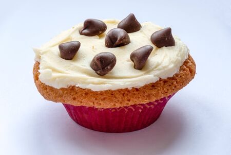 Homemade cupcakes with a buttercream frosting and chocolate chipsの写真素材