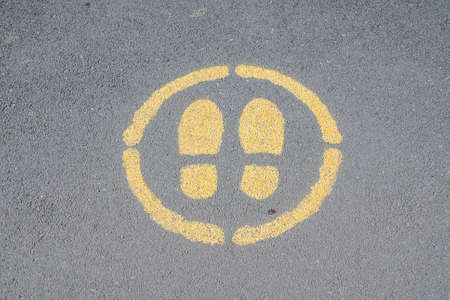 Sign painted on a pavement indicating where to standの写真素材
