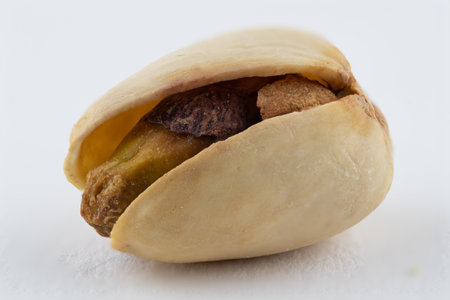 Close macro image of a pistachio nut isolated on a white backgroundの写真素材