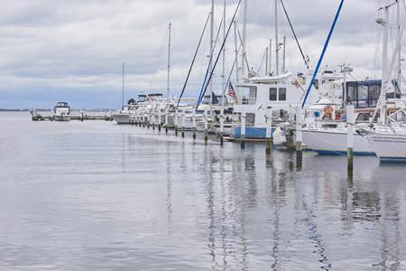 Punta Gorda, Florida Harbor with over-cast skies and fishing boats dockedの写真素材