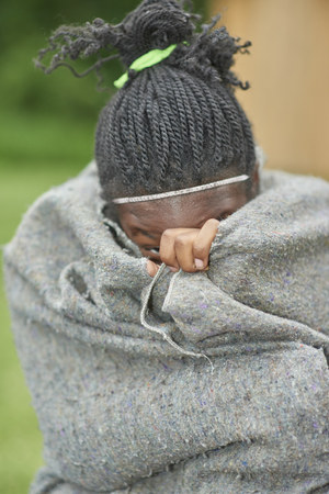 Summer 2014. Hiram House Camp. 4th. of July Celebration. Camper hiding in blanketのeditorial素材