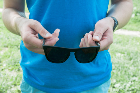 Black sunglasses in hand. Summer accessoryの写真素材