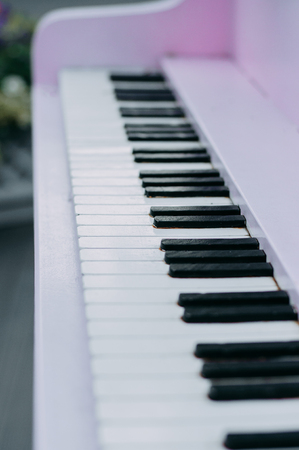 Pink piano keys in macro. Vintage music instrument closeupの写真素材