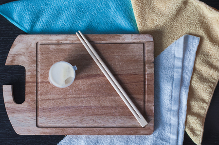 Chinese chopsticks with white sauce on the wooden board. Top view on the bamboo sticksの写真素材