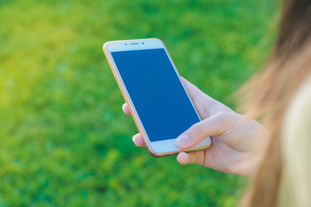 White smartphone mockup. Mobile phone in hands isolated