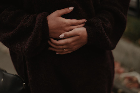 Stomach ache. Woman holding hands on the stomachの写真素材