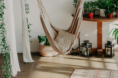 hammock in the manimalism bedroom interior. Pillows, plant