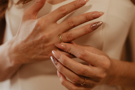 Woman removes the gold ring from the hand. Concept of the divorceの写真素材