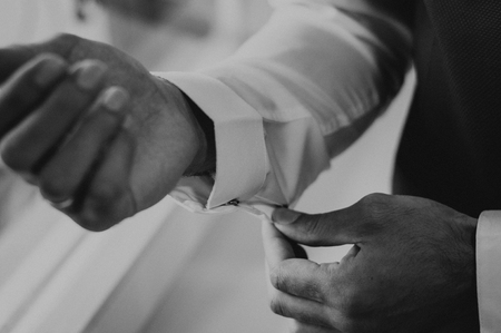 Man dress cufflinks in the wedding morning with white short. Elegant clothes