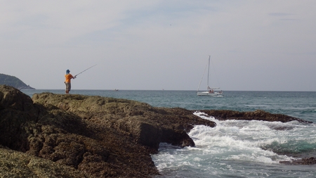 fisherman on the  Promthep Cape ,Nai Harn Beach, Phuket Island, Thailandの写真素材