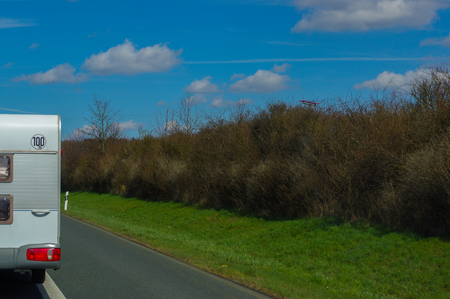 a part of a camper trailer on the highwayの写真素材