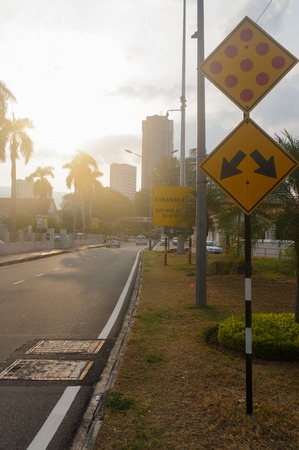 a city street at dusk with light trails and traffic signの写真素材