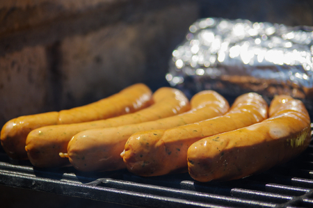 row of grilled sausages on a grill. bratwurst close upの写真素材