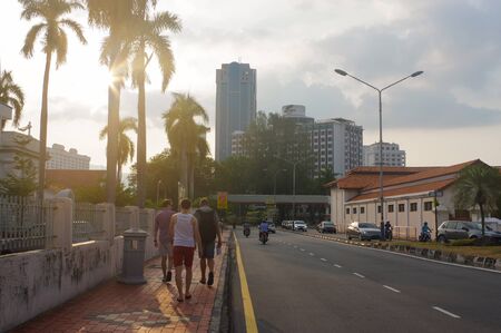 tourist at a city street in Penang, Georg Town, at dusk with light trails and traffic sign, Malaysia.のeditorial素材