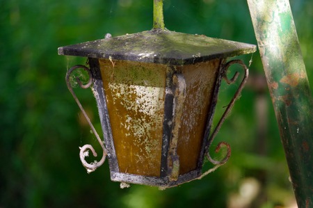 a vintage style street light with crown on the top. Beautiful historical retro metal Streetlight on green tree background.の写真素材