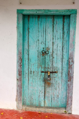 a closed old blue wooden door. Mediterranean style exterior.の写真素材