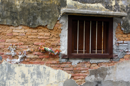 Georgetown, Penang, Malaysia - April 18, 2016: old brick wall with a wooden windowのeditorial素材