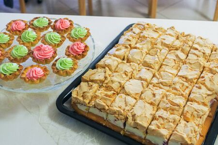 a cheese cake on a plate and muffins, cupcakes decorated