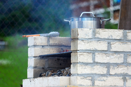 a Traditional rich bbq fireplace, made from brics, in gardenの写真素材