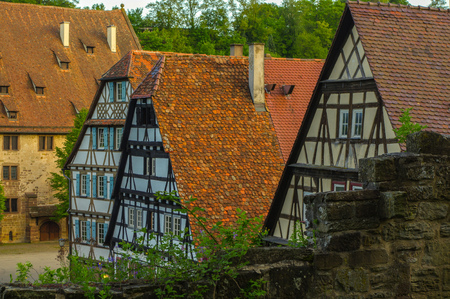 MAULBRONN, GERMANY - MAI 17, 2015: row of Tudor style houses at the monastery courtyard in Maulbronn. Cistercian Monastery Maulbronn is part of the UNESCO World Heritage Site.の写真素材