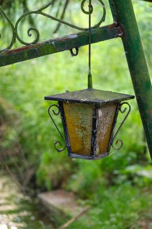 a vintage style street light with crown on the top. Beautiful historical retro metal Streetlight on green tree background.の写真素材