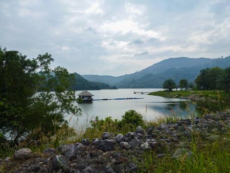Lake Bang Wad on Phuket Island in the afternoon, Thailand. Landscape with a cloudy sky and karstic mountains in the background. Southeast Asia.の写真素材