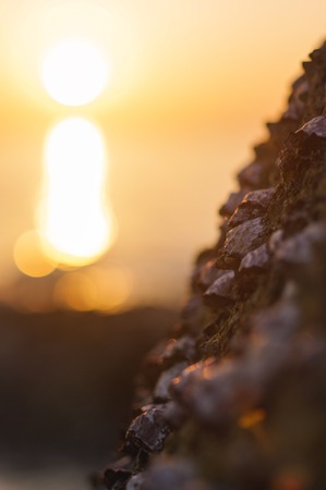 sea wave closeup at sunset time with red and orange sun reflection on the water. nature abstract blurred background. Phuket island, Thailand.の素材 [FY31092734344]