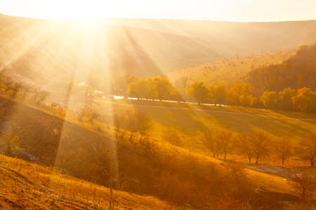 rays of sun over autumn landscapeの写真素材
