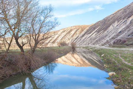 hills reflected in river waterの写真素材