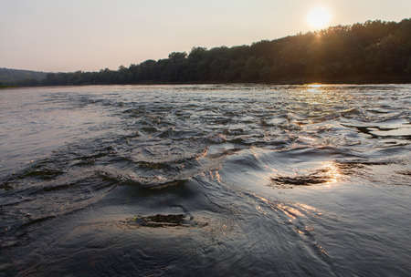 sun over the fast river