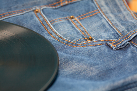 vinyl disc on jeansの写真素材