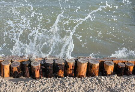 waves splashing on the wooden barsの写真素材