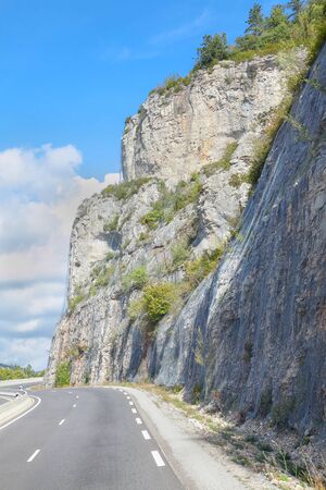 asphalt road near mountainの写真素材