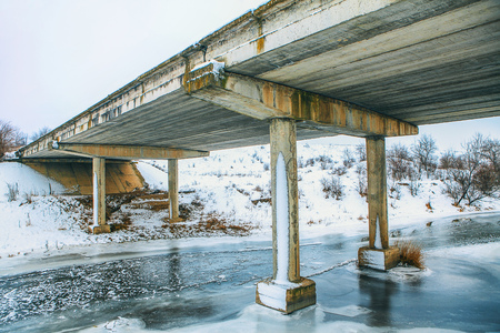 bridge over frozen riverの写真素材