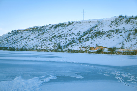 cross on the snowy hillの写真素材