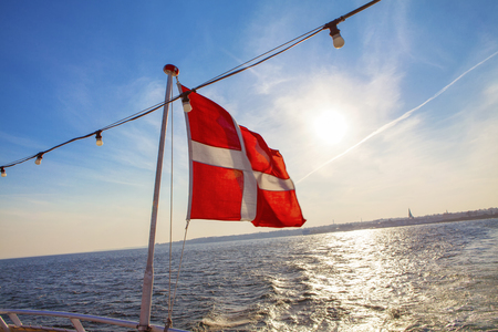 danish flag waving on the ship ropeの写真素材