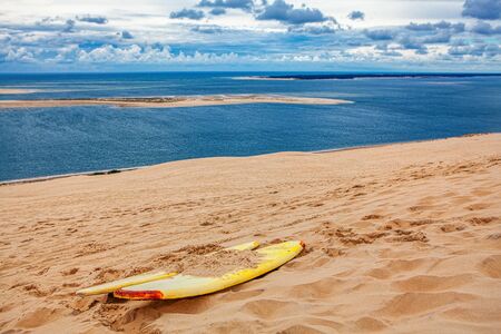 sandboard on the sandy duna near oceanの写真素材