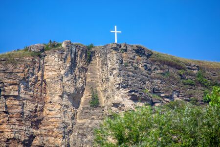 white orthodox cross on the mountain peakの写真素材