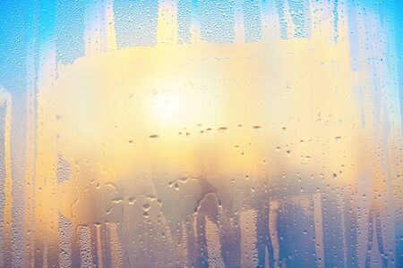 water drops and sunlight on the window glass