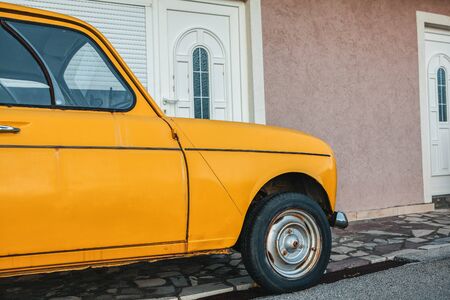 yellow retro car parked near the houseの写真素材